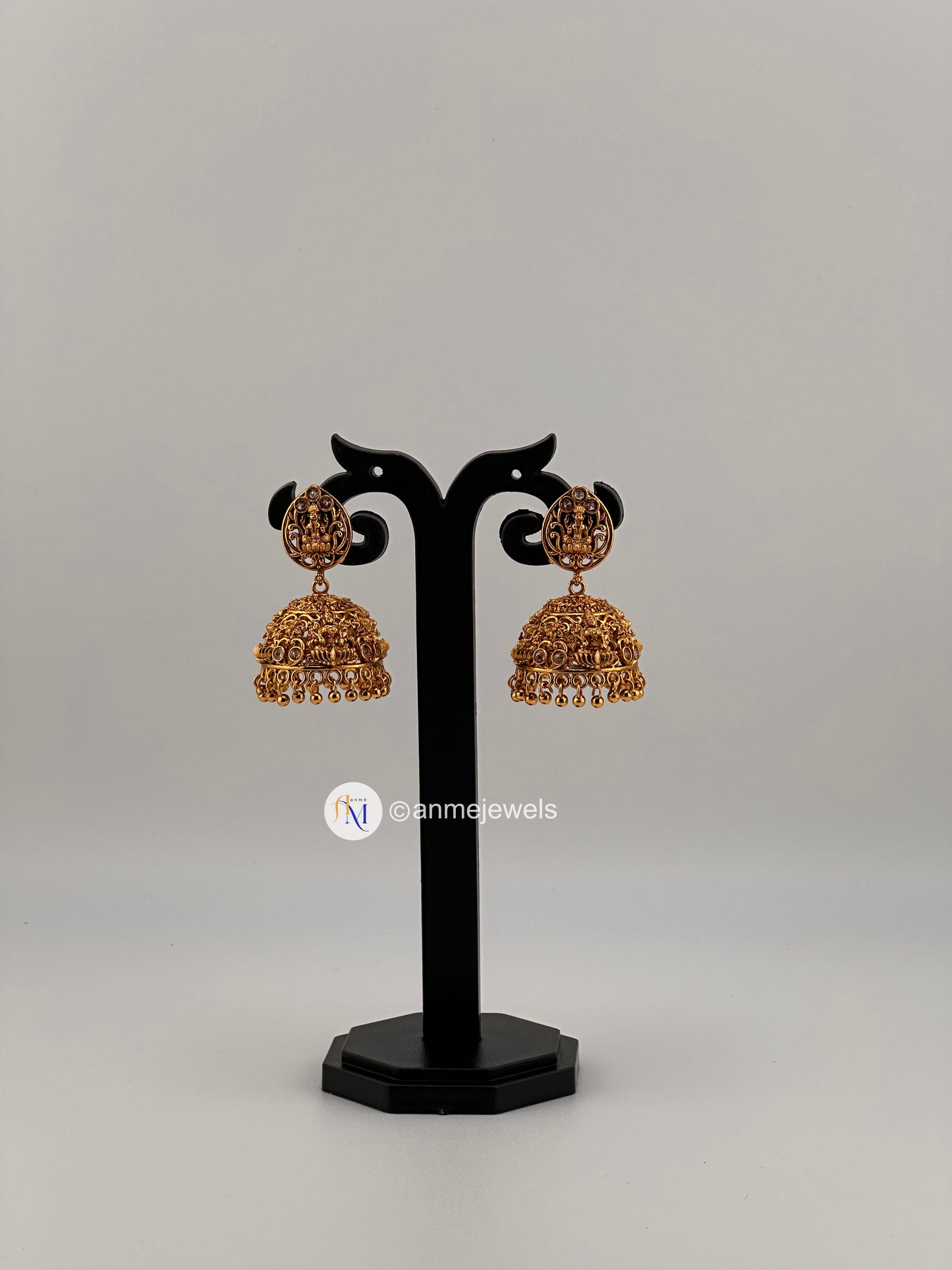 Temple style Lakshmi design golden with white stone jhumkas(gold hangings and white pearl hangings)
