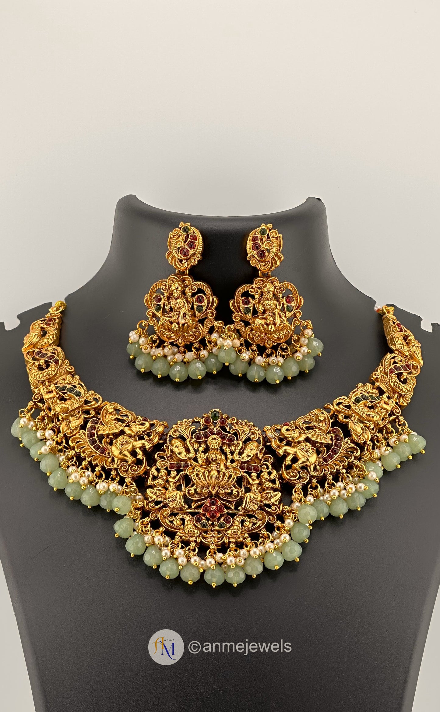 Beautiful Lakshmi pendant with temple motifs with pastel and pearl hangings necklace set with earrings