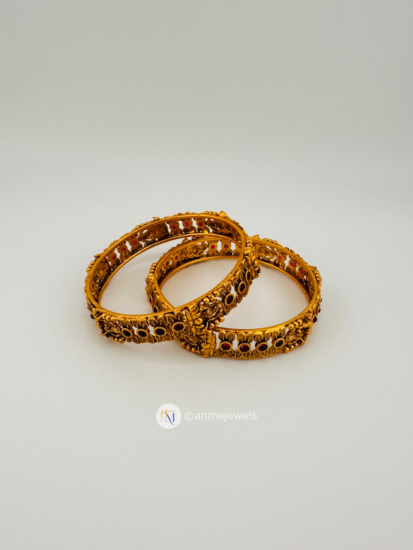 Elegant matte finish ruby floral and goddess lakshmi bangle set
