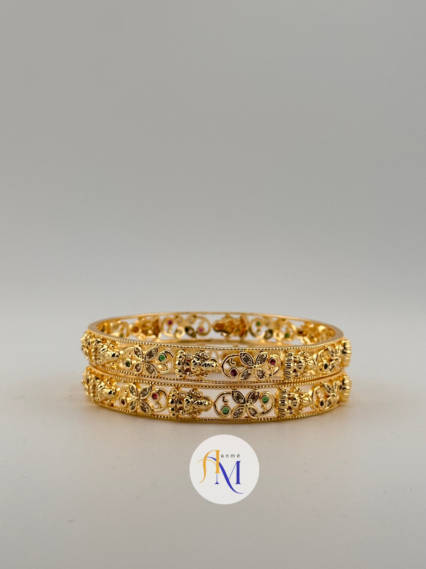 Bright Lakshmi and floral design with ruby green and white stone bangles(Set of 2)