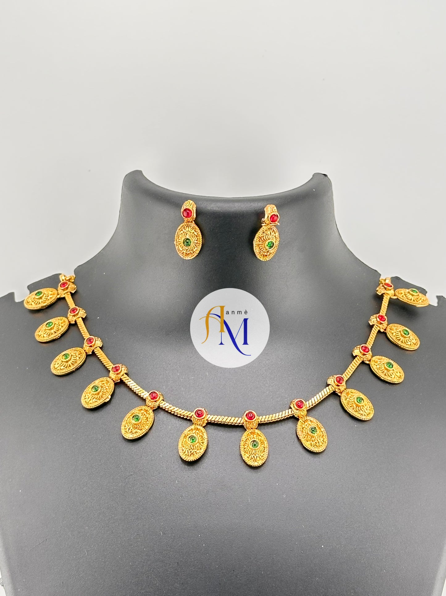 Antique oval coin necklace set with ruby-green stones