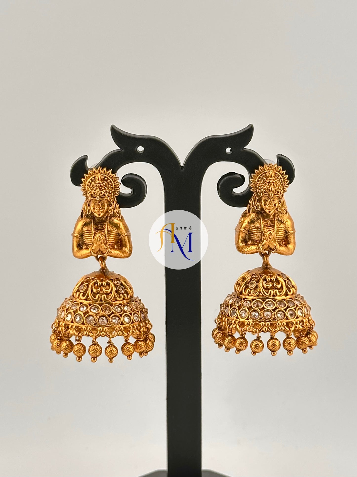 Beautiful woman figurine with classic bell-shaped jhumka design, adorned with colorful stones