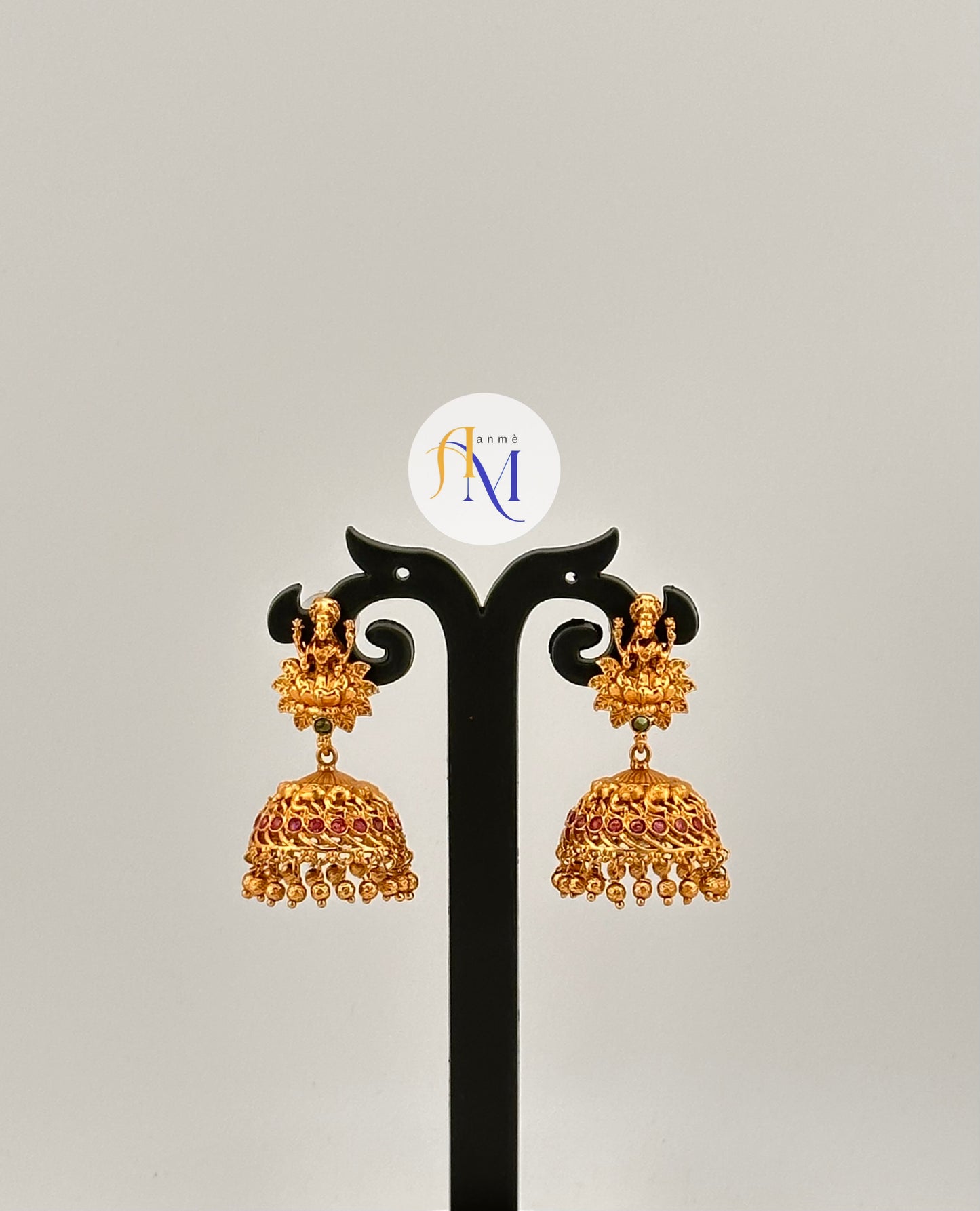 Unique Goddess Lakshmi motif Jhumkas enhanced with single green stone and multiple ruby stones