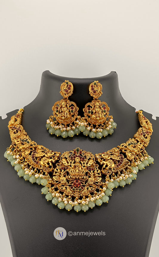 Beautiful Lakshmi pendant with temple motifs with pastel and pearl hangings necklace set with earrings