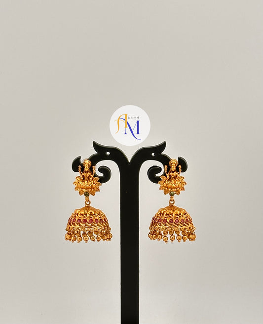 Unique Goddess Lakshmi motif Jhumkas enhanced with single green stone and multiple ruby stones