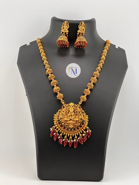 Beautiful Lakshmi pendant with ruby-green stones and maroon and white pearl hangings with Jhumka earrings