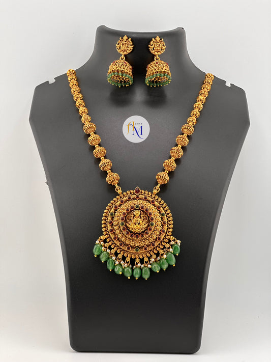 Beautiful round lakshmi pendant with ruby-green stones and pastel and white pearl hangings with Jhumkas