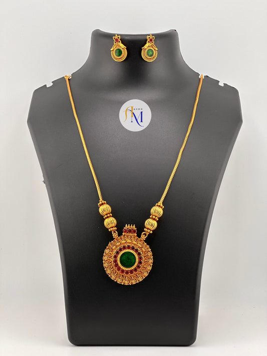 Beautiful round pendant with ruby-green stones and lakshmi motifs with simple chain and earrings